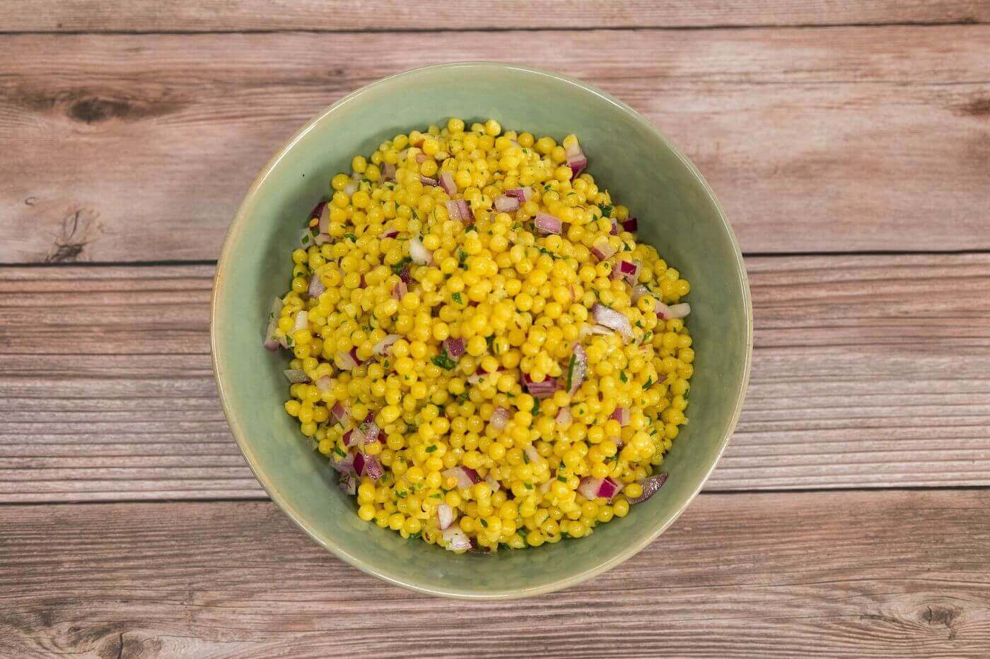 Herb Israeli Cous Cous in a green bowl