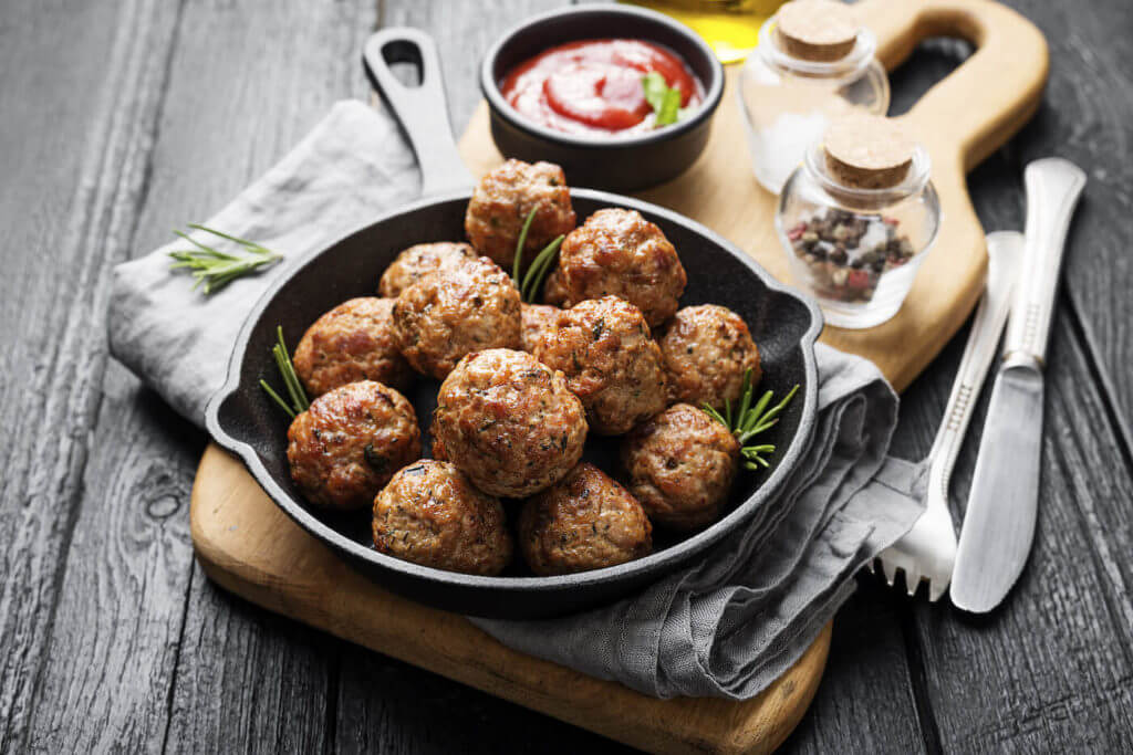 Meatballs served with tomato sauce in frying pan