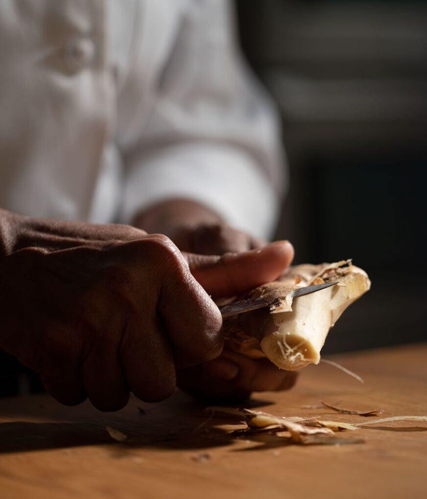 Chef peeling ginger