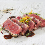 Five slices of ahi tuna tataki with a soy vinaigrette
