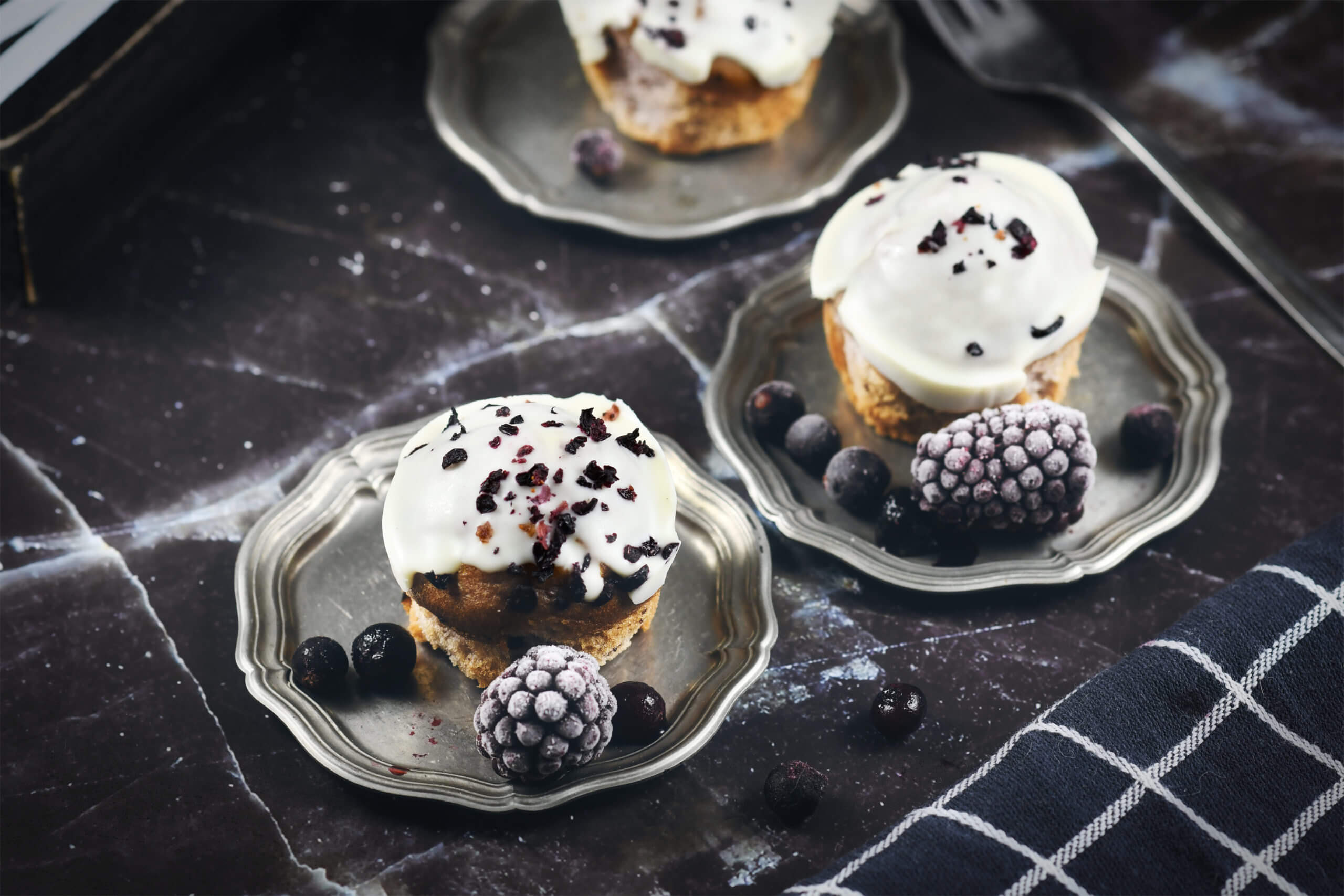 Blueberry and blackberry muffins with white frosting