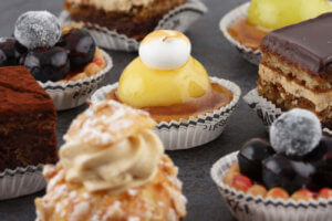 Close up photo of different pastries displayed on a black table