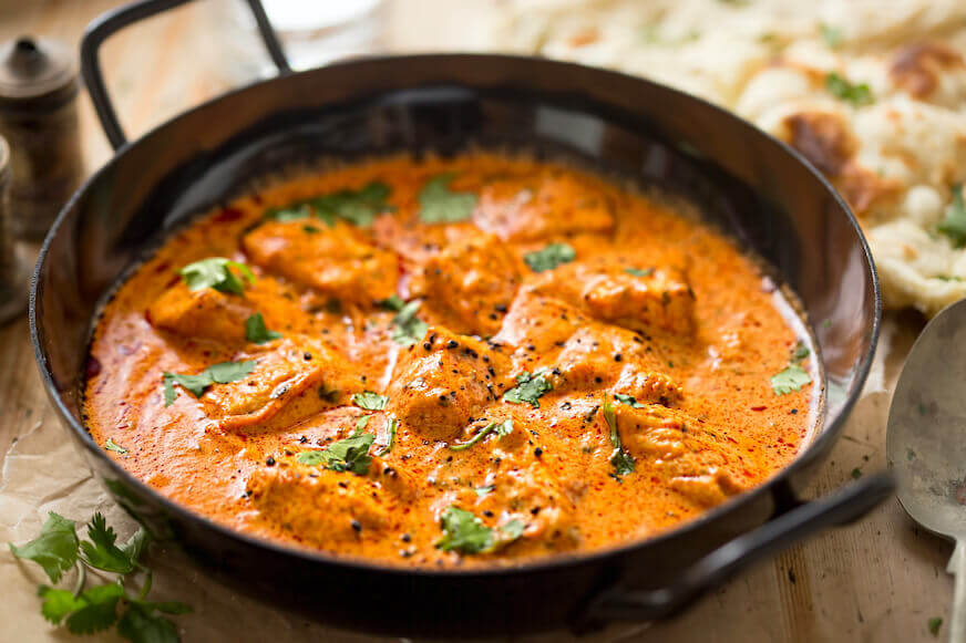 Butter chicken curry in a large pan
