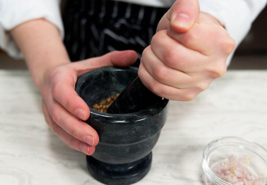 Chef making a green curry paste