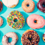 Assorted donuts on pastel blue background