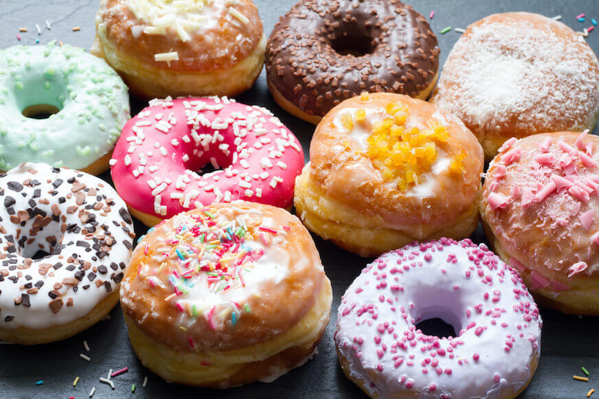 Close up of colorful yeast and cake doughnuts