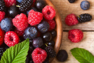 Mixed berries in a wooden bowl on a table