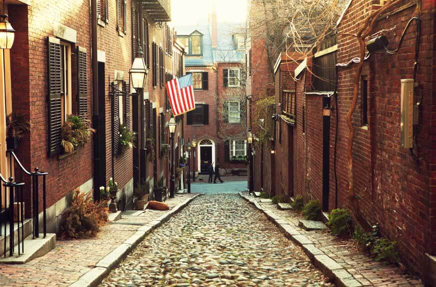 quaint view of a narrow Boston cobblestone street in Beacon Hill