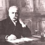 auguste escoffier sitting on desk