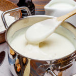 white bechamel sauce in a pan and ingredients