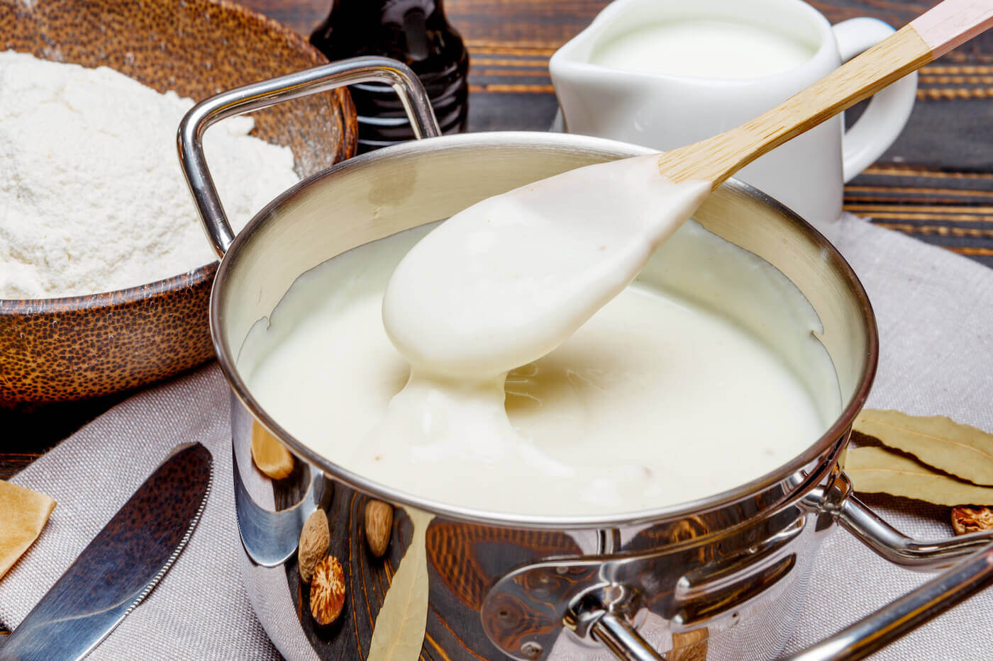 white bechamel sauce in a pan and ingredients