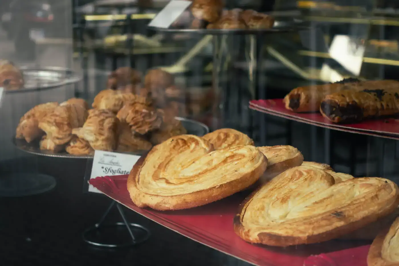 A display of palmiers in the window display of a bakery.