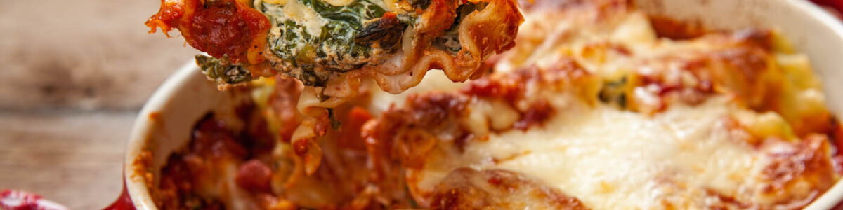 Baked lasagna with ricotta cheese in a red dish