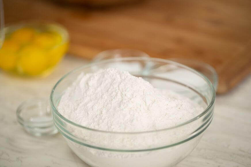 Flour and eggs in glass bowls