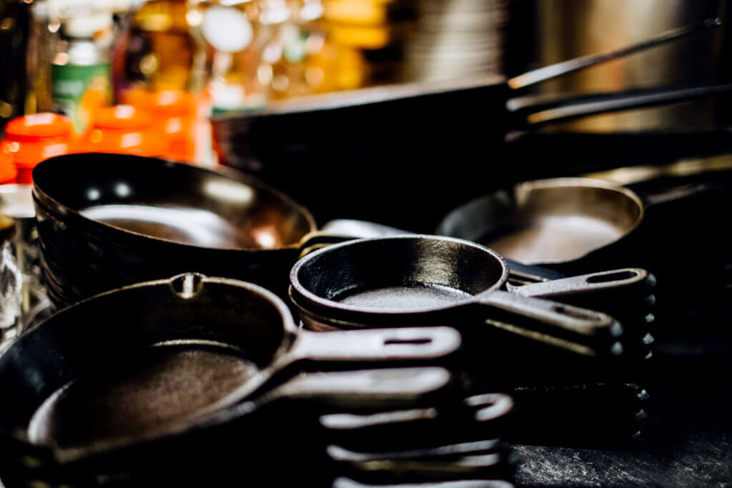 Cast iron pans and skillets stacked together