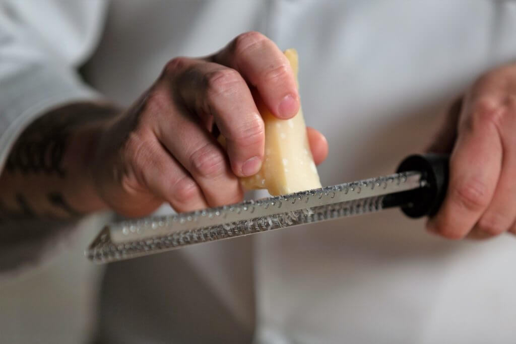 Grating cheese on cheese grater