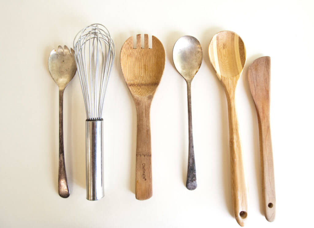 Wooden and metal spoons with a whisk