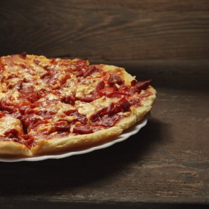 round pizza on wood background