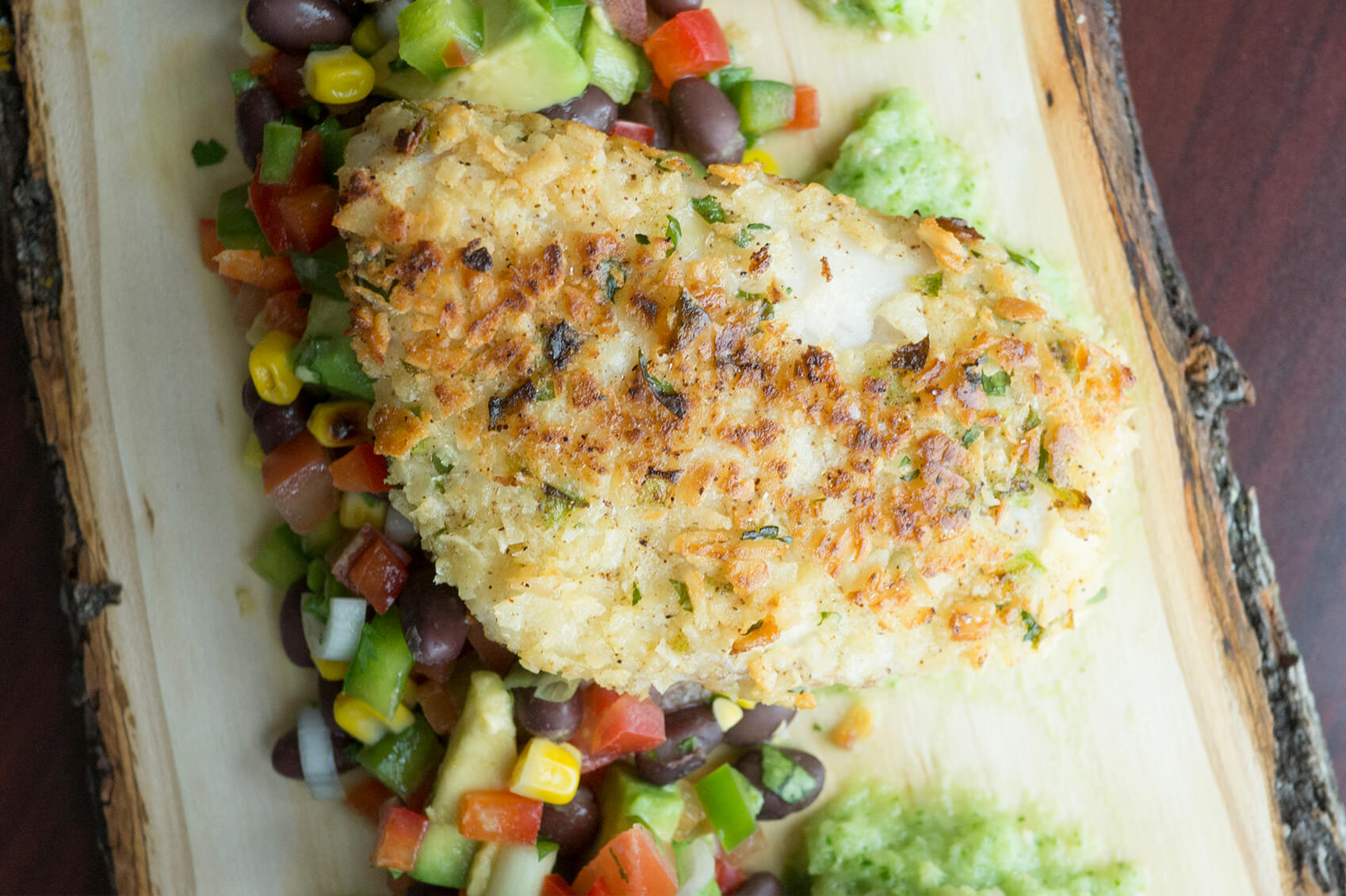 Pair your tortilla crusted tilapia with a black bean and corn salsa and tomatillo sauce.