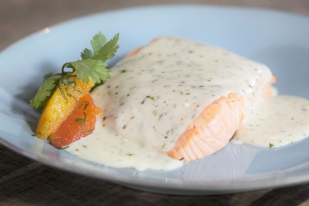 The tarragon cream sauce pairs perfectly with the tender poached salmon.