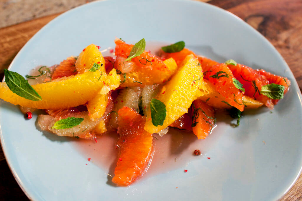 Garnish the salad with fresh mint, shaved pink peppercorns and a pinch of salt.