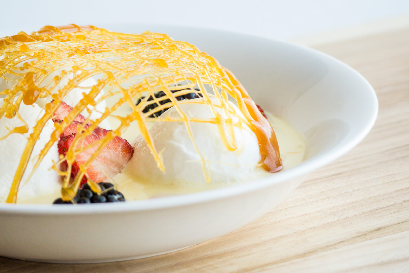 The floating island dessert of creme Anglaise, poached meringue and spun sugar.