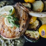 Stuffed pork chops with pan seared vegetables and a lemon caper sauce.