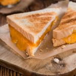 Coating each side of the bread with butter allows them to brown evenly.