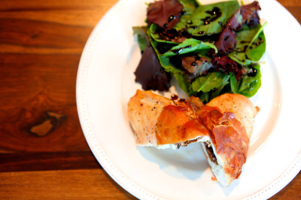 A mixed greens salad is the perfect pairing for this stuffed chicken.