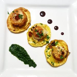 Crispy mushroom and truffle ravioli with seared scallops, spinach puree and a pomegranate reduction sauce by Escoffier graduate, Ashley Vazquez