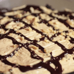 Garnish the pie with peanuts and a chocolate sauce drizzle.