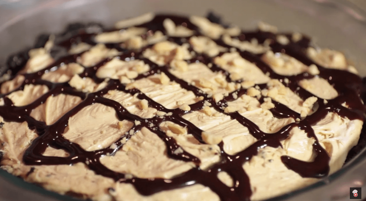 Garnish the pie with peanuts and a chocolate sauce drizzle.