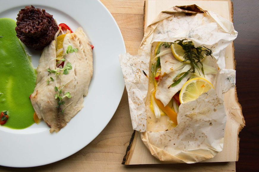 You can serve this dish in the parchment paper or taking it out and plating it.