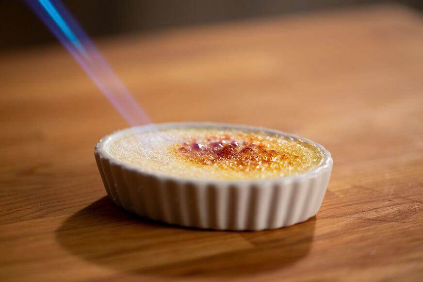 Close up of flame torching Crème Brûlée