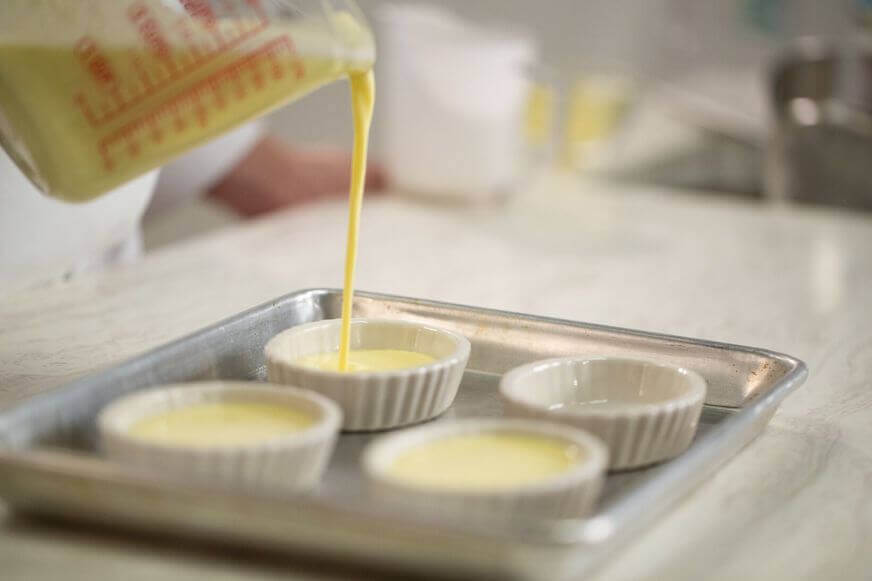 Pouring Crème Brûlée Custard from a measuring cup