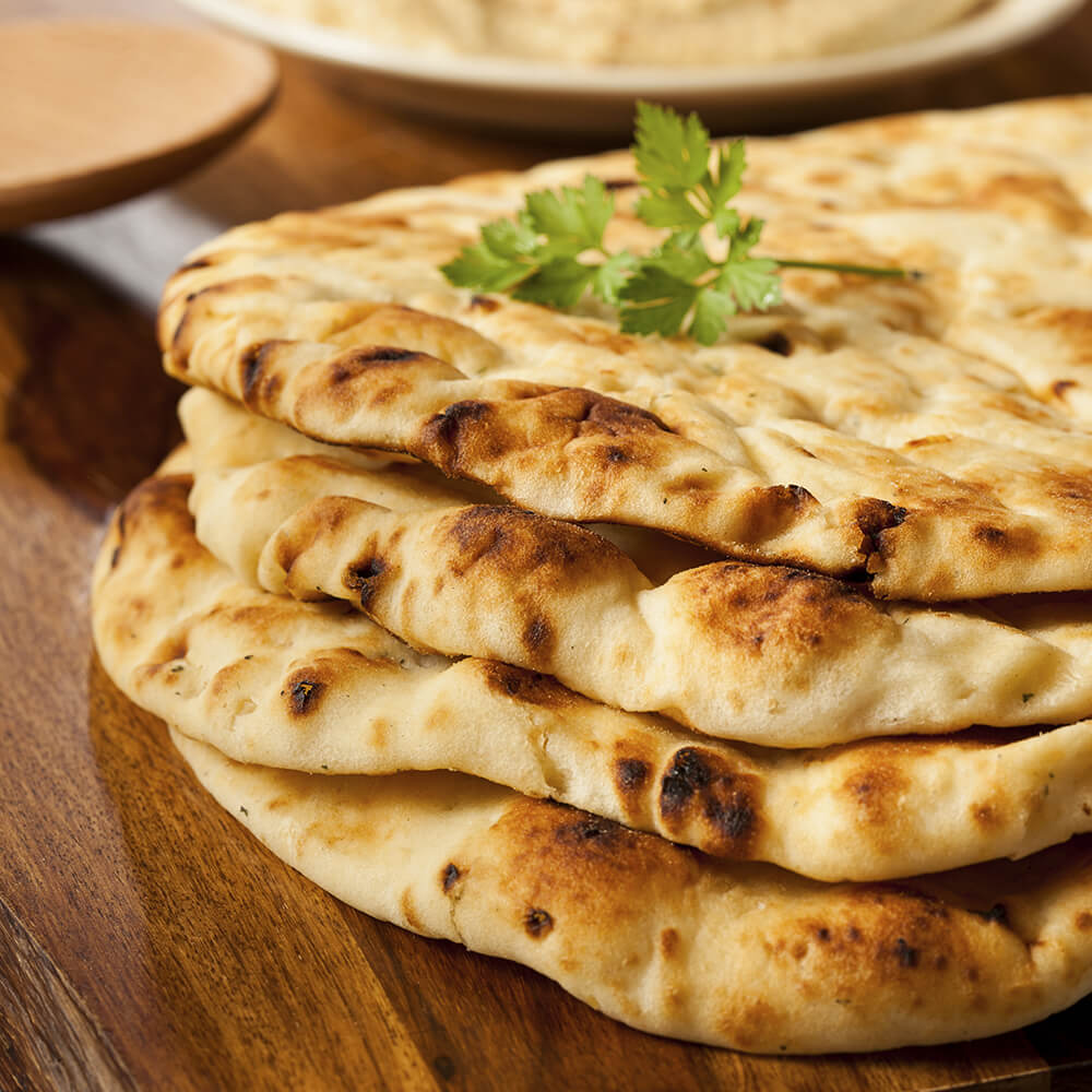 Naan is often served alongside entrees in Indian cuisine.