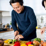 Couple chopping vegetables in the kitchen