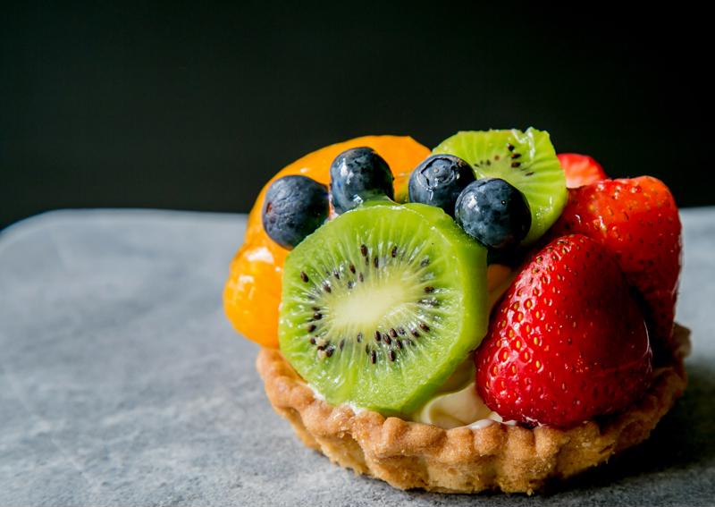 Fruit tart on black and white background.