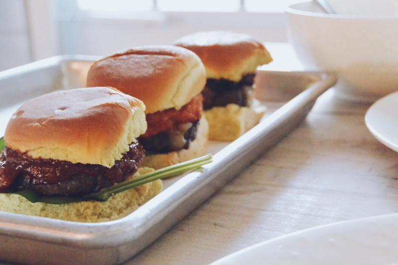 Burger sliders on a tray.
