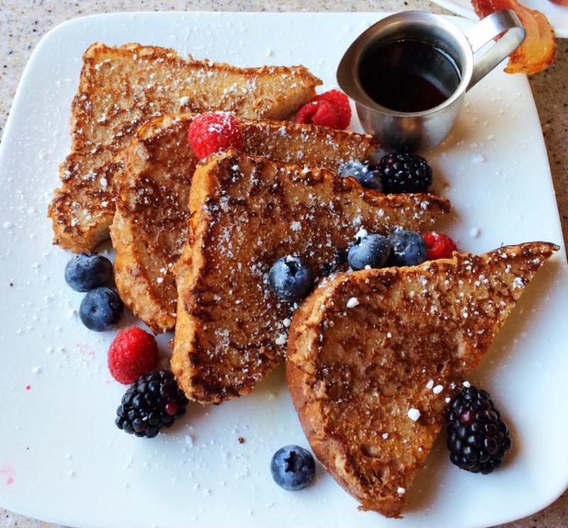Top your French toast with berries and syrup.