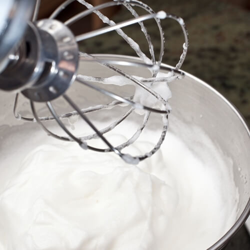 The meringue part of a Buche de Noel should have stiff, glossy peaks.